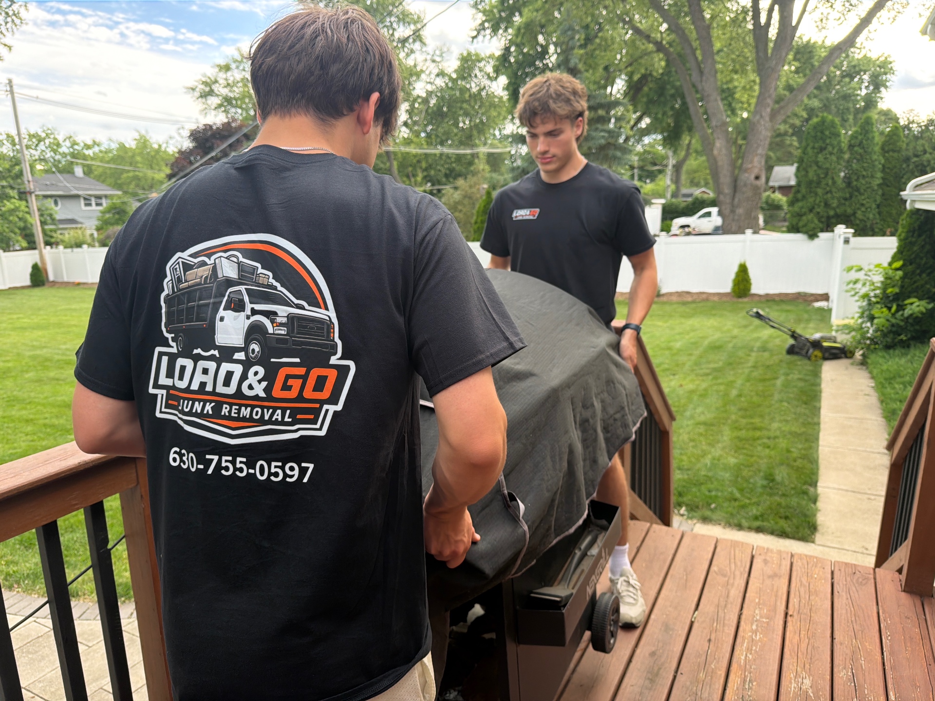 Junk removal crew loading a truck during a garage cleanout